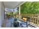 Spacious covered porch with plenty of seating, stylish rugs, and a view of the surrounding greenery at 1209 Cottage Ave, Indianapolis, IN 46203