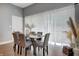 Elegant dining area with seating for six and a sliding glass door at 1209 Cottage Ave, Indianapolis, IN 46203