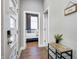 Inviting hallway with a view of a bedroom, welcome sign, and light-filled doorway at 1209 Cottage Ave, Indianapolis, IN 46203