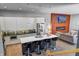 Open kitchen layout with stainless steel appliances, an island with seating, and a modern fireplace at 1209 Cottage Ave, Indianapolis, IN 46203