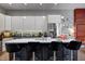 Stylish kitchen features a large island with seating, stainless steel refrigerator, and sleek cabinetry at 1209 Cottage Ave, Indianapolis, IN 46203
