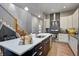 Contemporary kitchen featuring a spacious island, stainless steel appliances, and elegant pendant lighting at 1209 Cottage Ave, Indianapolis, IN 46203