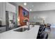 Open-concept kitchen showcases a quartz island overlooking the cozy living room with a fireplace and TV at 1209 Cottage Ave, Indianapolis, IN 46203