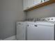 Well-lit laundry room featuring a white Maytag washer and dryer, and white cabinets for ample storage at 1209 Cottage Ave, Indianapolis, IN 46203
