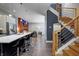 Open floor plan connecting a modern kitchen, living room with fireplace and staircase with wood treads at 1209 Cottage Ave, Indianapolis, IN 46203