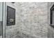 Modern tiled shower stall with gray and white brick-style tiles and sleek fixtures at 1209 Cottage Ave, Indianapolis, IN 46203
