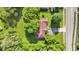 Overhead shot of a house with green lawn and mature trees; with a long driveway at 12121 East 21St St, Indianapolis, IN 46229