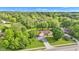 Aerial view of home with mature trees, lush green yard and a long driveway on a sunny day at 12121 East 21St St, Indianapolis, IN 46229