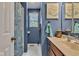 Stylish bathroom with blue walls, a modern vanity, and charming beach-themed decor at 12121 East 21St St, Indianapolis, IN 46229
