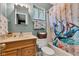 Cozy bathroom featuring a vanity with sink, toilet, and a shower with a fun, decorative shower curtain at 12121 East 21St St, Indianapolis, IN 46229