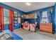 Vibrant bedroom featuring blue walls, a bunk bed, and colorful decorations, ideal for  at 12121 East 21St St, Indianapolis, IN 46229