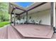 Spacious covered deck featuring wood beams, outdoor seating, and ample room for entertaining in a private outdoor setting at 12121 East 21St St, Indianapolis, IN 46229