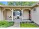 Inviting covered porch with a 'Welcome' sign, decor, and charming accents, enhancing the home's curb appeal at 12121 East 21St St, Indianapolis, IN 46229