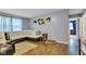 Light-filled living room with hardwood flooring, an L-shaped couch, and decor enhancing its cozy atmosphere at 12121 East 21St St, Indianapolis, IN 46229