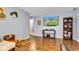 Welcoming living room featuring wood floors, a modern TV, and stylish decor, enhancing the home's appeal at 12121 East 21St St, Indianapolis, IN 46229