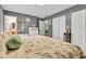 Main bedroom with gray walls, plush carpet, a patterned quilt, and lots of storage space at 12121 East 21St St, Indianapolis, IN 46229