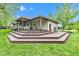 Multi-tiered deck and covered area, offering outdoor living space and scenic views of the well-maintained backyard at 12121 East 21St St, Indianapolis, IN 46229
