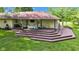 Expansive multi-level deck is ideal for outdoor entertaining and enjoying the serene views of the backyard at 12121 East 21St St, Indianapolis, IN 46229