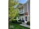 Townhouse featuring a private balcony with a view of lush greenery and a well-manicured lawn at 1280 Shadow Ridge Rd, Indianapolis, IN 46280