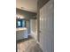 Bright bathroom with modern vanity, large mirror, and shower-tub combo, lit by modern lighting at 1280 Shadow Ridge Rd, Indianapolis, IN 46280
