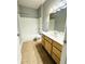 Bright bathroom featuring a shower-tub combo, wood vanity, and tile floors at 1280 Shadow Ridge Rd, Indianapolis, IN 46280