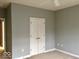 A well-lit bedroom featuring carpeted floors, a double-door closet, and neutral paint at 1280 Shadow Ridge Rd, Indianapolis, IN 46280