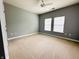 Neutral bedroom featuring carpeted floors, a ceiling fan, and sun-filled windows at 1280 Shadow Ridge Rd, Indianapolis, IN 46280