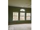 Spacious bedroom with neutral walls, three large windows, and cozy carpet at 1280 Shadow Ridge Rd, Indianapolis, IN 46280