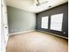 Neutral bedroom featuring carpeted floors, a ceiling fan, and sun-filled windows at 1280 Shadow Ridge Rd, Indianapolis, IN 46280