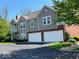 An exterior shot of a townhouse featuring a two-car garage and a second-story balcony at 1280 Shadow Ridge Rd, Indianapolis, IN 46280