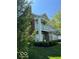 Two-story home with a second-floor balcony, lawn, and manicured shrubbery at 1280 Shadow Ridge Rd, Indianapolis, IN 46280