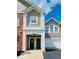 Inviting townhome featuring an attached garage, brick accents, and a covered porch entrance at 1280 Shadow Ridge Rd, Indianapolis, IN 46280