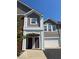 Charming condo exterior with a two-car garage and well-maintained landscaping and neutral siding at 1280 Shadow Ridge Rd, Indianapolis, IN 46280