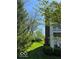 Scenic view of the property with lush green lawn, mature trees, and manicured bushes at 1280 Shadow Ridge Rd, Indianapolis, IN 46280