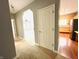 Hallway view leading to a kitchen with stainless steel appliances and a bright bedroom at 1280 Shadow Ridge Rd, Indianapolis, IN 46280