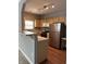 Efficient kitchen with stainless steel appliances, wooden cabinets, and warm wood-look flooring at 1280 Shadow Ridge Rd, Indianapolis, IN 46280