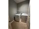 Functional laundry room with washer, dryer, and wire shelving at 1280 Shadow Ridge Rd, Indianapolis, IN 46280