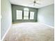 Bright bedroom with three windows, neutral walls, and carpet, illuminated by a ceiling fan at 1280 Shadow Ridge Rd, Indianapolis, IN 46280