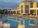 Community pool area with many chairs and clear blue water reflecting the sunset sky at 1280 Shadow Ridge Rd, Indianapolis, IN 46280