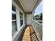 Welcoming covered porch with wood flooring and white railings at 1280 Shadow Ridge Rd, Indianapolis, IN 46280