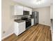 Bright kitchen featuring stainless steel appliances, white cabinets, and modern countertops providing a delightful cooking experience at 13094 N Etna Green Dr, Camby, IN 46113