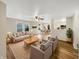Bright living room featuring stylish furnishings, hardwood floors, and seamless flow into dining area at 13094 N Etna Green Dr, Camby, IN 46113