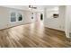 Open-concept living area with hardwood floors, bright windows, and a seamless transition to the kitchen at 13094 N Etna Green Dr, Camby, IN 46113