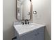 Bathroom vanity featuring a marble countertop, bronze mirror, and matte black hardware at 1313 Kenwood Dr, Greenwood, IN 46143