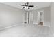 Spacious bedroom with neutral carpet, ceiling fan, and multiple closet options at 1313 Kenwood Dr, Greenwood, IN 46143