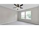 Cozy bedroom with neutral walls, carpet, ceiling fan, and bright windows at 1313 Kenwood Dr, Greenwood, IN 46143