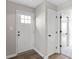 Foyer with light-colored walls, wood floors, front door, and access to other rooms at 1313 Kenwood Dr, Greenwood, IN 46143