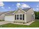 Classic exterior with garage, window, and clean landscaping at 1313 Kenwood Dr, Greenwood, IN 46143