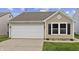 Charming home featuring a garage, well-manicured lawn, and a classic window design at 1313 Kenwood Dr, Greenwood, IN 46143