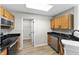 Well-lit kitchen featuring wooden cabinets, granite countertops, and modern appliances at 1313 Kenwood Dr, Greenwood, IN 46143